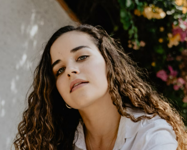 a girl with curly hair in a shirt